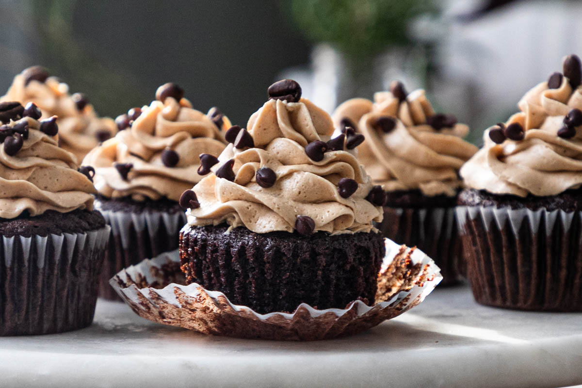Image of chocolate coffee cupcakes with mini chocolate chips and coffee beans.
