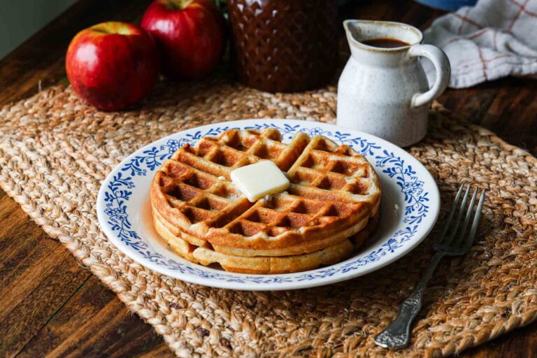 Apple Waffles on a plate with a pat of butter.