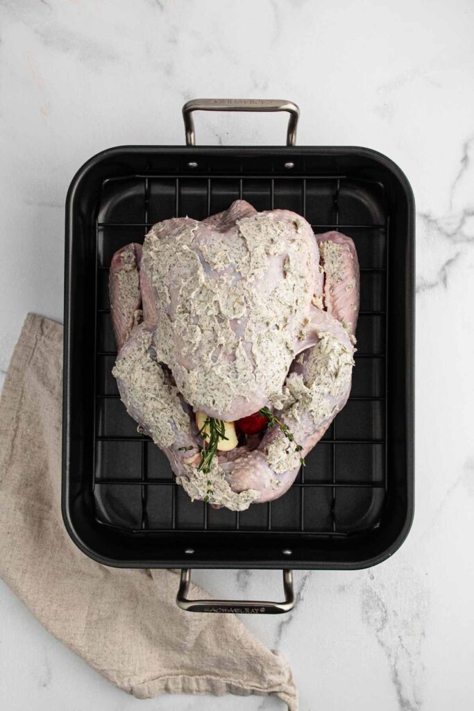 Raw turkey in black pan.
