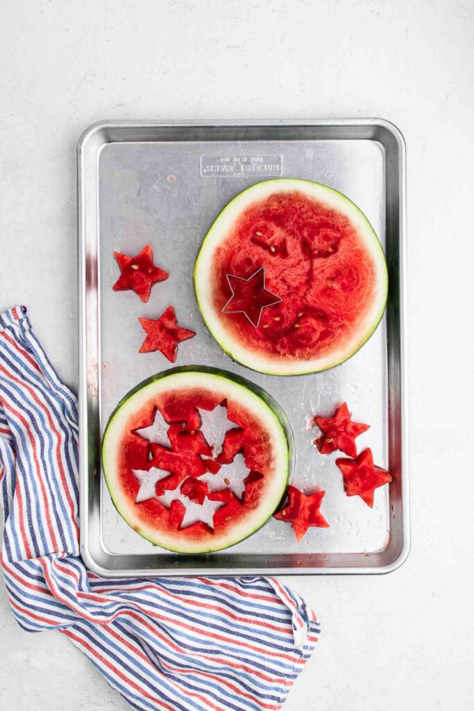 Cutting stars out of watermelon slice.